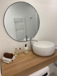 ein Badezimmer mit einem Waschbecken und einem Spiegel auf der Theke in der Unterkunft Appartement boho chic près de la plage in Cambrils