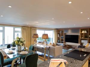 a living room with a couch and a table at Solent View Apartment in West Cowes