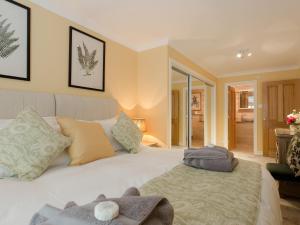 a bedroom with a white bed with two pillows at Solent View Apartment in West Cowes