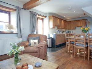 a living room with a couch and a table at Smugglers Retreat in Hartland