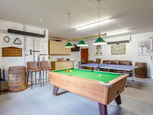 a living room with a pool table and some chairs at Ard Taigh in Stron-fearnan