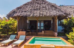 a villa with a swimming pool and a hut at Kasha Boutique Hotel in Matemwe
