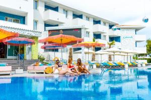 three girls sitting in the pool at a hotel at Sotavento Club Apartments - Adults Only in Magaluf