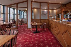 a restaurant with tables and chairs and a bar at Old Hunstanton Le Strange Arms Hotel in Hunstanton