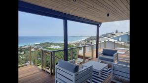a balcony with chairs and a view of the ocean at Brenton Ocean view in Brenton-on-Sea