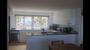 a kitchen with a counter top and a window at Brenton Ocean view in Brenton-on-Sea