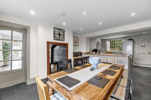 a dining room and kitchen with a table and chairs at NEW 2023 Modern Luxury Holiday Home on the Beach in Devon - Free Parking, Pets Welcome, Sleeps 10 in Plymouth
