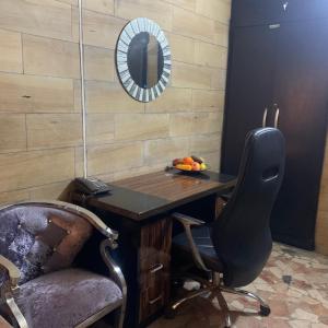 a desk with a chair and a mirror in a room at HPLagos in Lagos