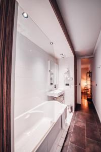 a white bathroom with a tub and a sink at COWOOL Cergy in Cergy +69 photos