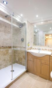 a bathroom with a shower and a sink at Old Hunstanton Le Strange Arms Hotel in Hunstanton