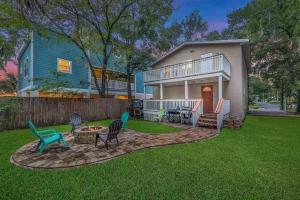 a yard with chairs and a table and a house at Spacious renovated 4br downtown home w firepit sleeps 8+ in Saint Augustine