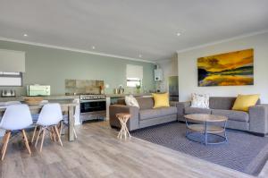 a living room with a couch and a table at Giantscup Wilderness Reserve in Underberg