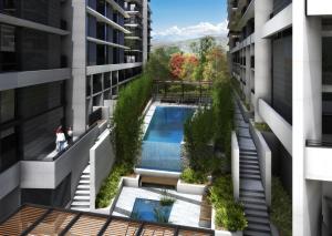 an overhead view of a building with a swimming pool at CityStyle Apartments - BELCONNEN in Canberra