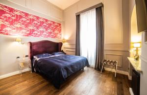 מיטה או מיטות בחדר ב-Relais San Lorenzo In Lucina