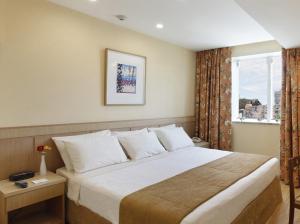 Cama ou camas em um quarto em Windsor Florida Hotel