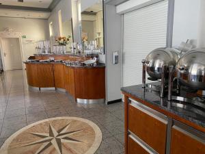 a bar in a restaurant with a counter with bowls at Gästehaus Kral in Erlangen +41 photos
