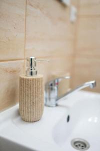 a toothbrush holder sitting on a bathroom sink at Casa Matteo - Rustic & cosy getaway in Zărnești in Zărneşti