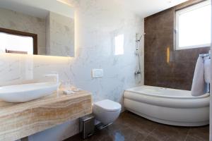 a bathroom with a sink and a toilet and a mirror at Perla Luxury in Ulcinj