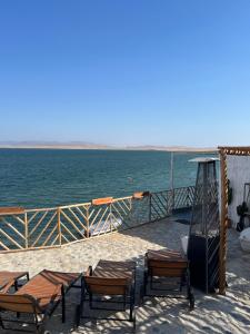 a group of chairs and tables on a pier near the water at Atenas Hotel Boutique in Paracas