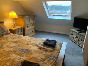 a bedroom with a large bed and a window at Pet Friendly Cottage Ashbourne with Parking in Ashbourne