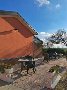 a patio with a table and benches and plants at Affittacamere Da Franco in Parma