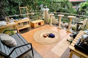 a patio with a bench and a table and a rug at Pallet Homes - Landheights in Iloilo City