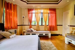 a bedroom with two beds and a window at Pallet Homes - Landheights in Iloilo City
