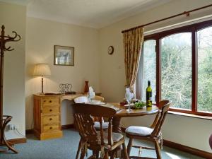 a dining room with a table and a window at Anvil in Dalbeattie