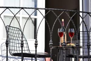 a table with two glasses of wine and a bottle at Zarbalı Cunda in Ayvalık