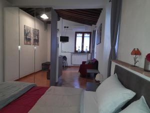 a bedroom with a bed and a living room at La casa in giardino in Volterra