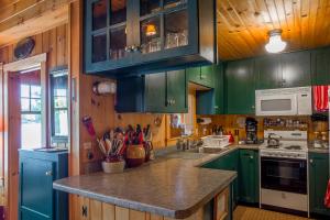 a kitchen with green cabinets and a counter top at FRE-Wil in Lincolnville