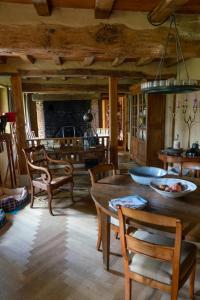 a living room with a wooden table and chairs at Cottage les forières in Saint-Honoré