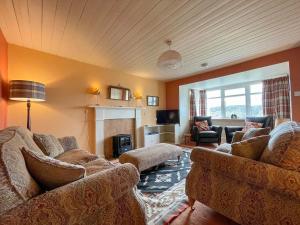 a living room with two couches and a fireplace at Dalcharn in Invernaver