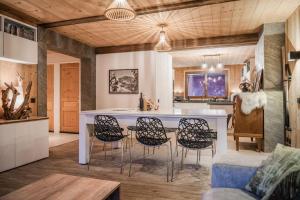 kuchnia i salon ze stołem i krzesłami w obiekcie Appartement Europa w mieście Briançon