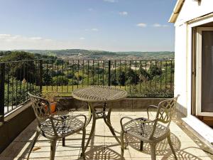 a table and chairs on a balcony with a view at Eastwood Lodge in Bath