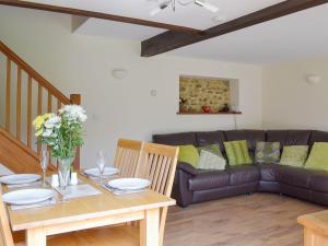 a living room with a table and a couch at Applebarrel Barn in Dunkeswell