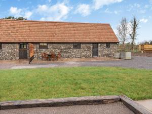 a stone house with a table and chairs in front of it at Russet-uk41836 in Clevedon