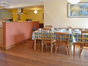 a dining room with a table and chairs at Fenham Barn in Soulby