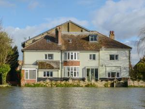 a house in the middle of a body of water at Riverside House in Beccles