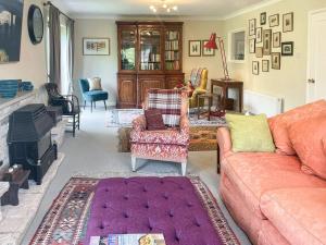 a living room with a couch and chairs at Millbrook in Bere Regis