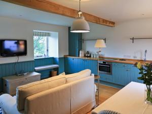 a living room with blue cabinets and a couch at The Granary in Crocketford