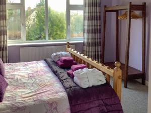 a bedroom with a bed with towels on it at New House Farm Annexe in Neenton