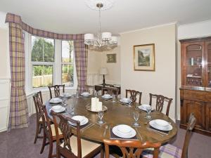 a dining room with a table and chairs at Haddon Villa in Bakewell