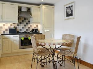 a kitchen with a table and chairs in a kitchen at Mickle Hill Mews in Gargrave