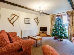 a living room with a christmas tree and a couch at Archway Barn - E3864 in Runcton Holme