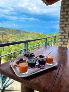 a tray of food sitting on a wooden table at Stone Maisonettes in Aigio