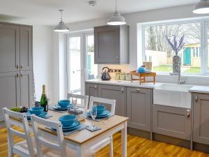 a kitchen with a table with blue dishes on it at Key To The Esk in Longtown