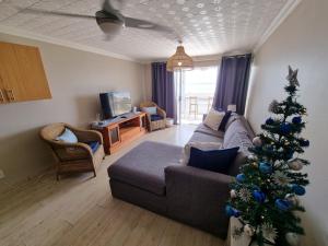 a living room with a christmas tree and a couch at Diaz Views 10 in Jeffreys Bay