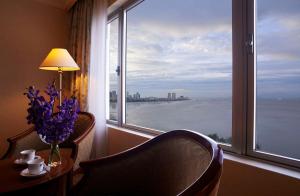a living room with a window overlooking the ocean at Evergreen Laurel Hotel Penang in George Town