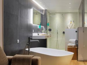 a bathroom with a tub and a sink and a shower at Hotel Saratoga in Palma de Mallorca